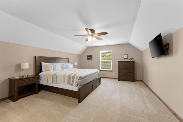 bedroom featuring ceiling fan, vaulted ceiling, baseboards, and light colored carpet