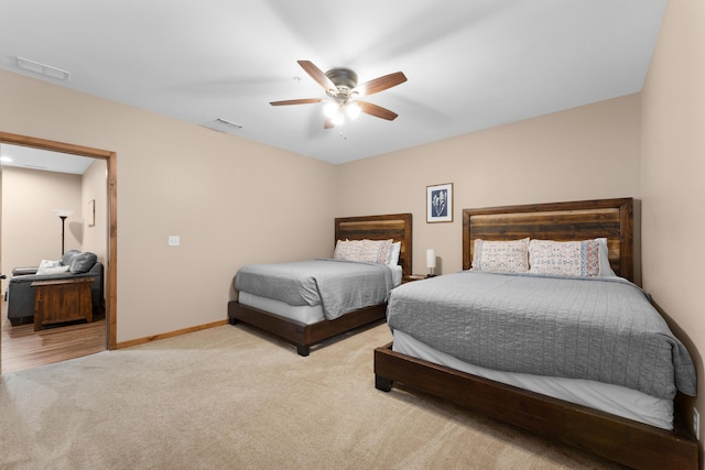 bedroom with baseboards, visible vents, carpet floors, and ceiling fan