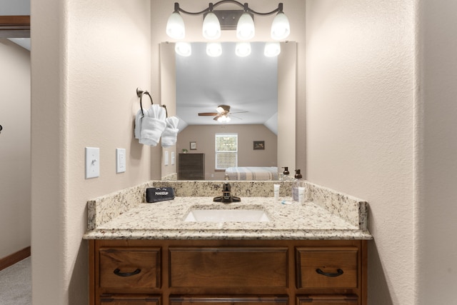 bathroom with lofted ceiling, vanity, and ceiling fan