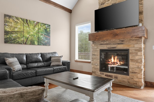 living room with lofted ceiling, light hardwood / wood-style floors, and a fireplace