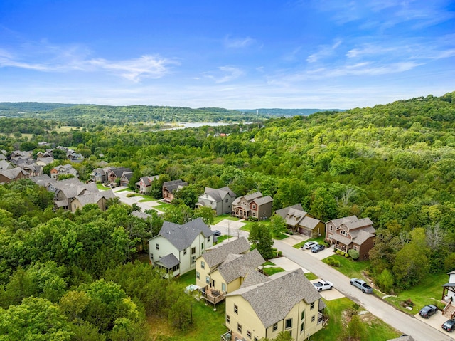 drone / aerial view with a forest view and a residential view