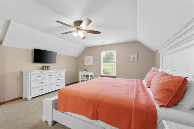 bedroom with ceiling fan, vaulted ceiling, and light colored carpet