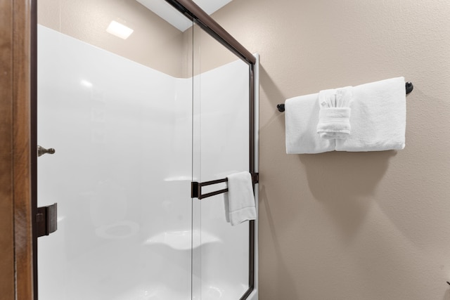 bathroom with a shower with shower door