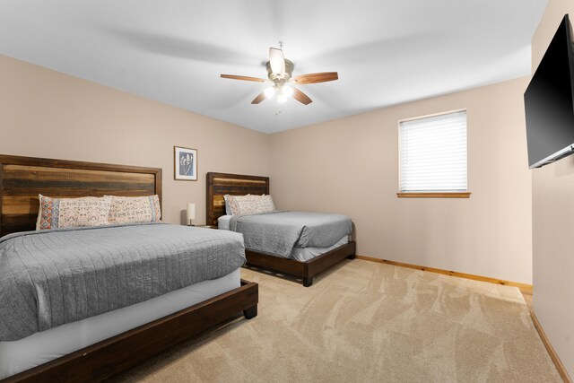 bedroom with light colored carpet and ceiling fan