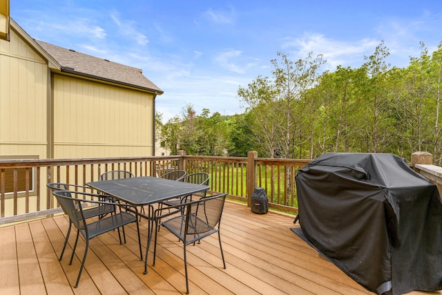 wooden deck featuring grilling area and outdoor dining area