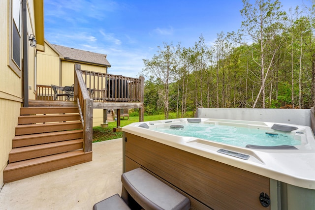 view of swimming pool featuring a hot tub and a deck