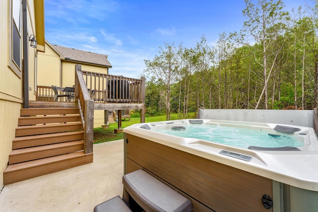 view of patio featuring stairway, a hot tub, and a deck