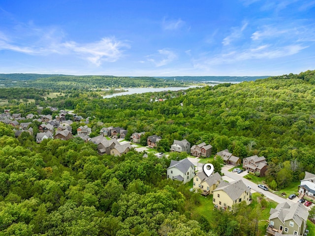 aerial view featuring a view of trees, a residential view, and a water view