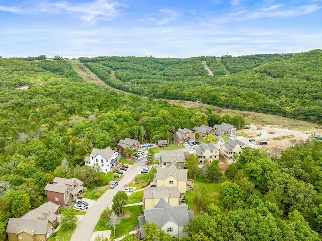 birds eye view of property featuring a residential view and a wooded view