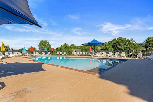 pool featuring a patio area and fence