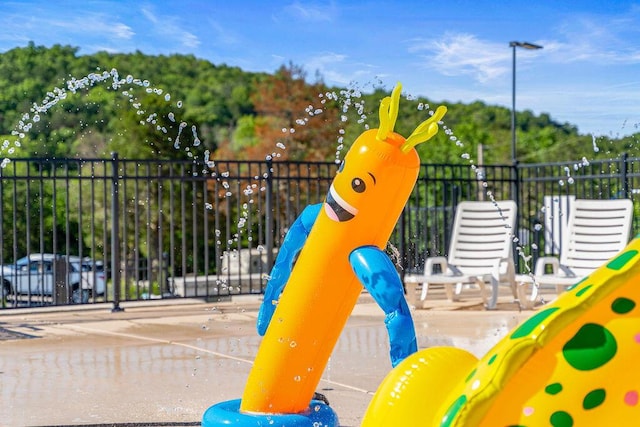 view of jungle gym with fence