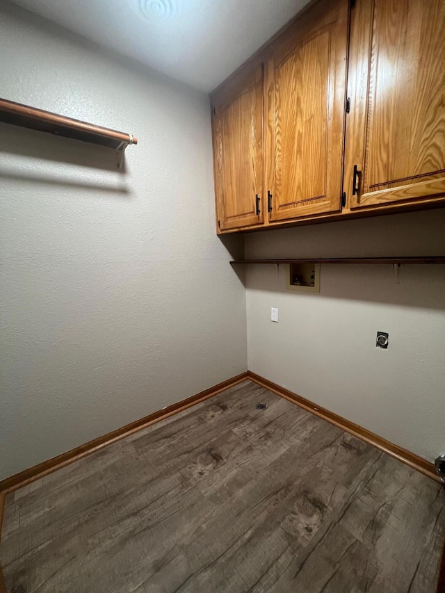 washroom with hookup for a washing machine, cabinets, dark wood-type flooring, and hookup for an electric dryer