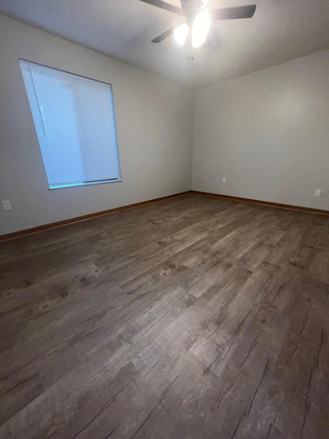 empty room with ceiling fan and wood-type flooring