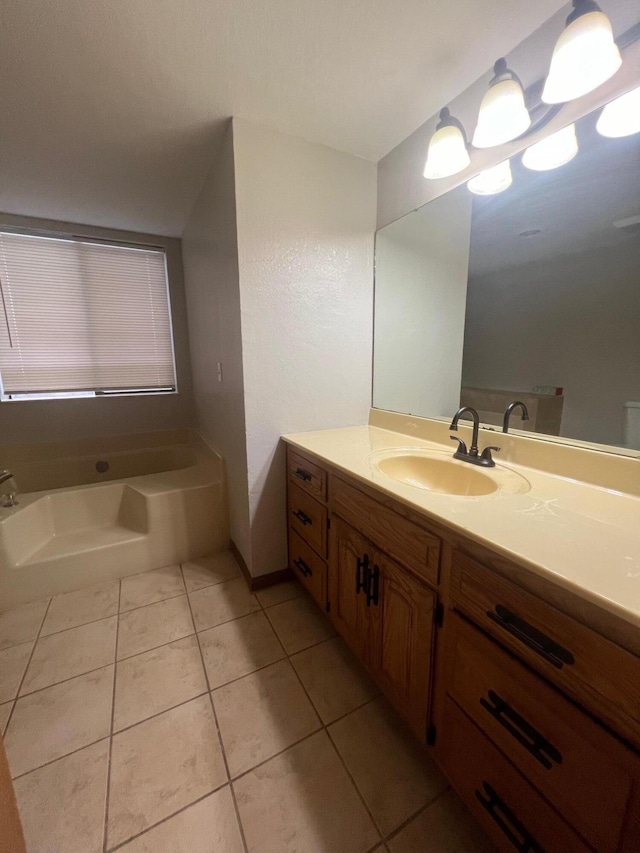 bathroom featuring vanity, tile patterned floors, and a tub