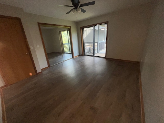 unfurnished room with ceiling fan and dark hardwood / wood-style floors