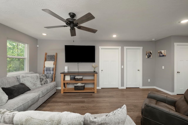 living room with hardwood / wood-style flooring, a textured ceiling, and ceiling fan