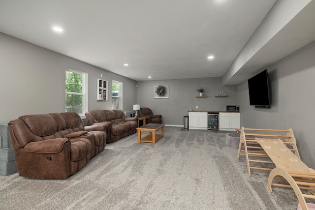 carpeted living room with wine cooler and bar area