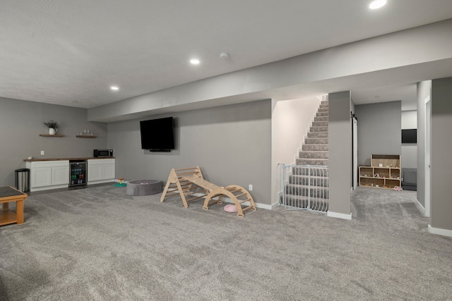 recreation room with indoor bar, light colored carpet, and wine cooler