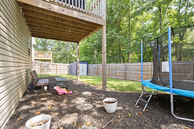 view of yard with a storage shed and a trampoline