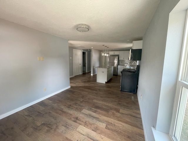 interior space featuring a textured ceiling, dark hardwood / wood-style flooring, and sink