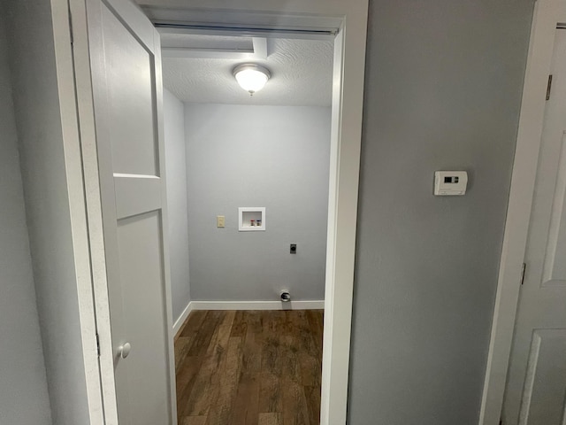 clothes washing area featuring hookup for an electric dryer, dark hardwood / wood-style floors, a textured ceiling, and hookup for a washing machine