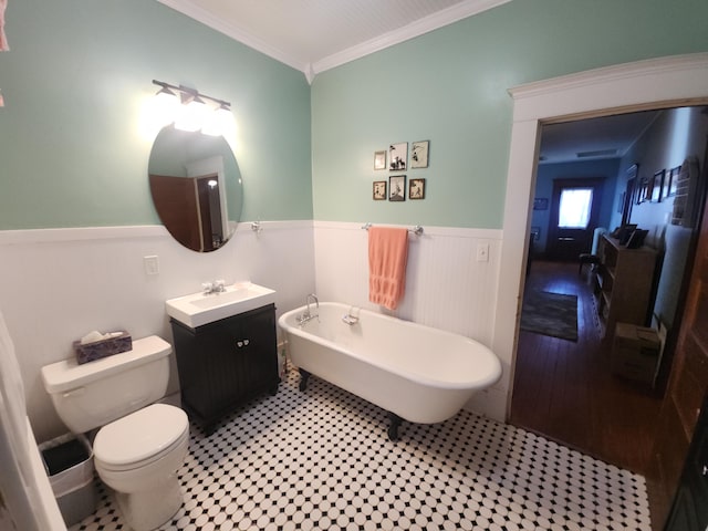 bathroom featuring toilet, wood-type flooring, crown molding, a bath, and vanity