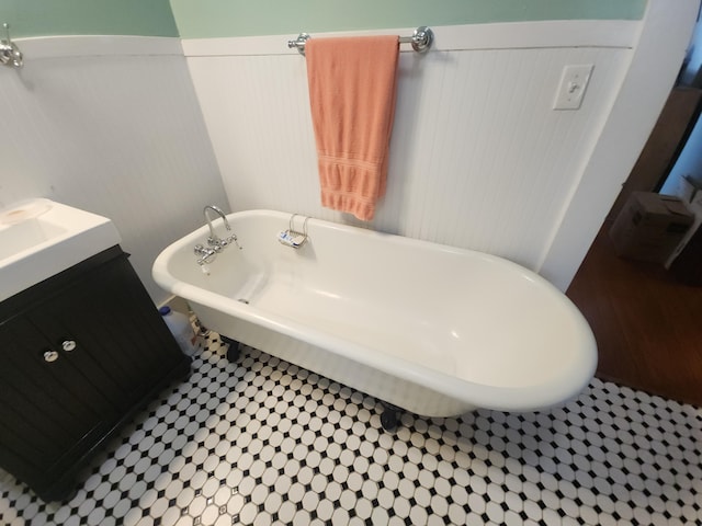 bathroom with a tub and vanity