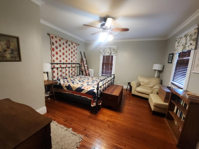 bedroom featuring dark hardwood / wood-style floors, crown molding, radiator heating unit, and ceiling fan