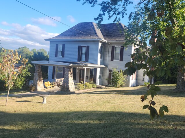 view of front of house with a porch and a front yard