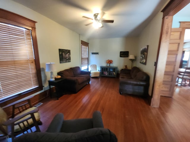 living room with ceiling fan, vaulted ceiling, and dark hardwood / wood-style flooring