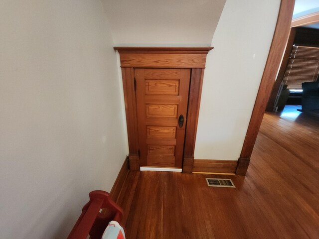 hallway with dark hardwood / wood-style flooring