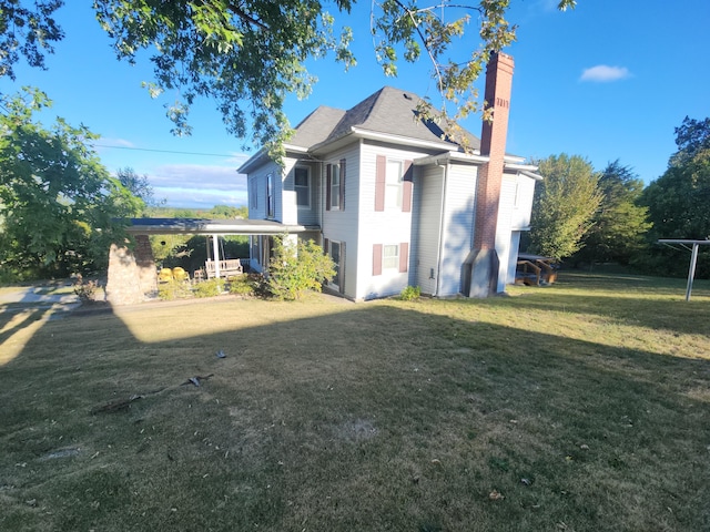 rear view of house with a yard