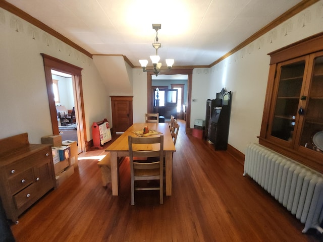 dining room with ornamental molding, a chandelier, radiator heating unit, and dark hardwood / wood-style floors