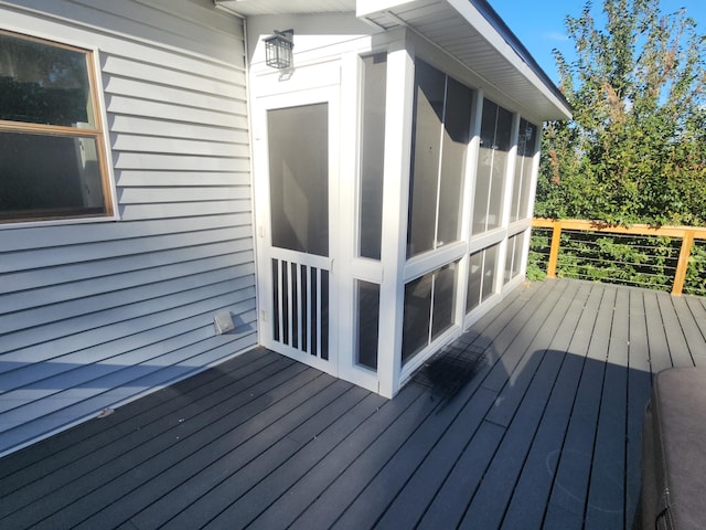 wooden deck with a sunroom