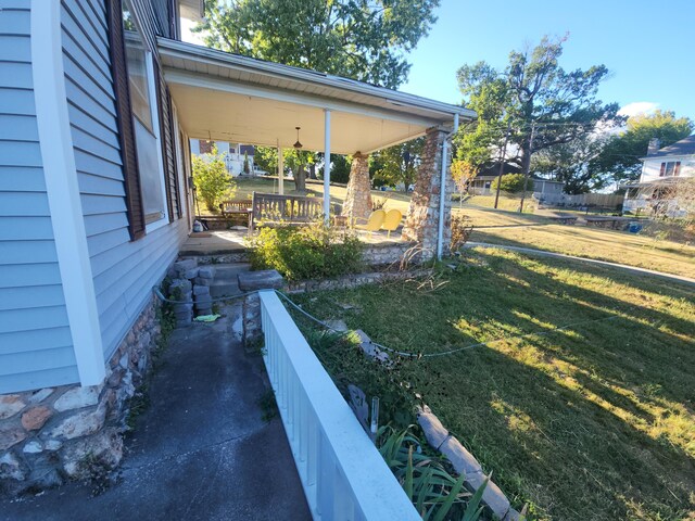 view of yard featuring covered porch