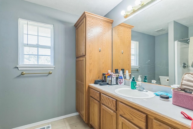 full bath featuring toilet, baseboards, visible vents, tile patterned flooring, and vanity