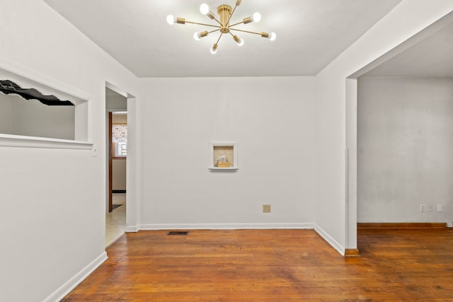 interior space featuring a chandelier and dark hardwood / wood-style flooring