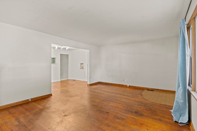 spare room with wood-type flooring