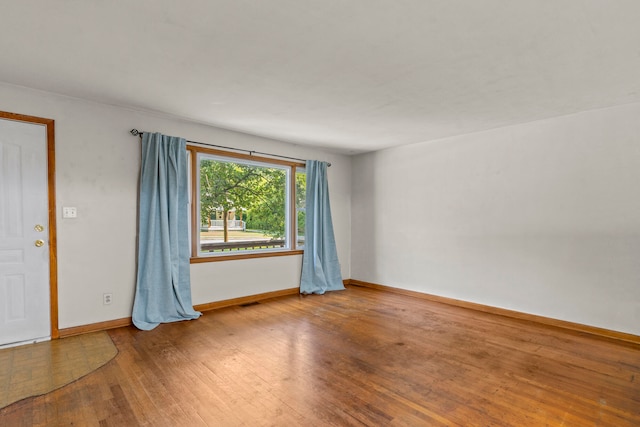 unfurnished room featuring hardwood / wood-style floors