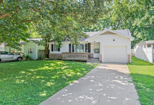 view of front of property featuring a front lawn and a garage