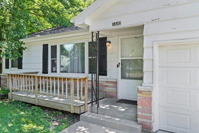 doorway to property with a garage