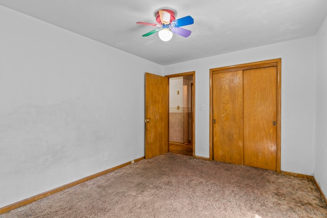 unfurnished bedroom with ceiling fan, a closet, and carpet flooring