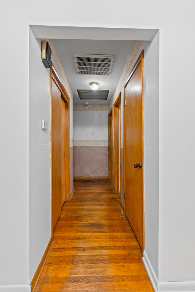 corridor with hardwood / wood-style floors