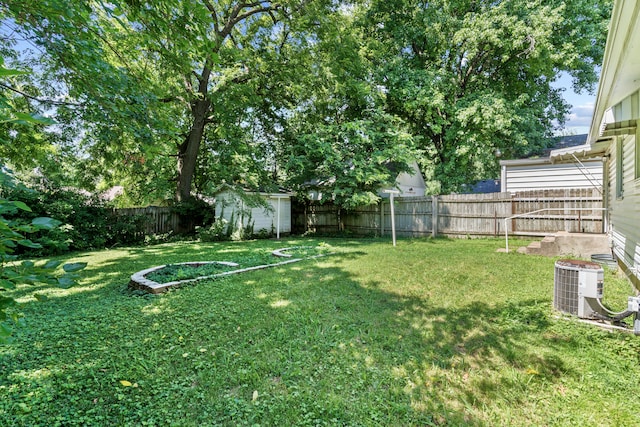 view of yard featuring central AC and a storage shed