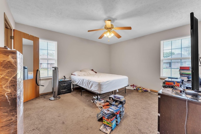 1130 S Arcadia Ave, Springfield, MO 65804 - carpeted bedroom with a textured ceiling, a ceiling fan, and baseboards