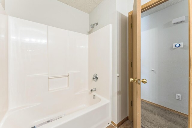 1130 S Arcadia Ave, Springfield, MO 65804 - bathroom featuring baseboards, a textured ceiling, and shower / bath combination