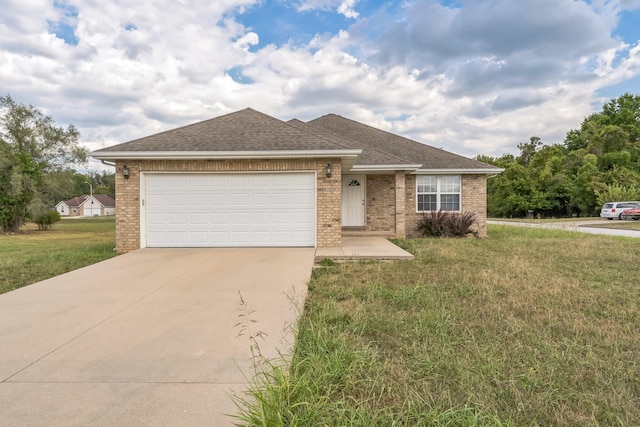 ranch-style home with a garage and a front lawn