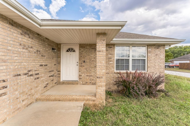 1130 S Arcadia Ave, Springfield, MO 65804 - view of exterior entry featuring brick siding and roof with shingles