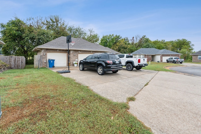 view of side of property featuring a garage and a lawn