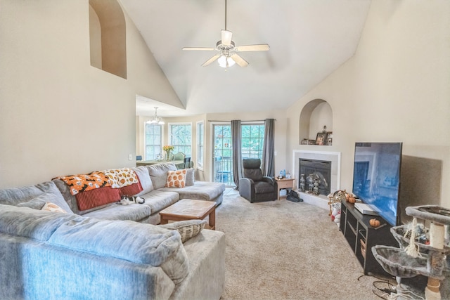 carpeted living room with high vaulted ceiling and ceiling fan